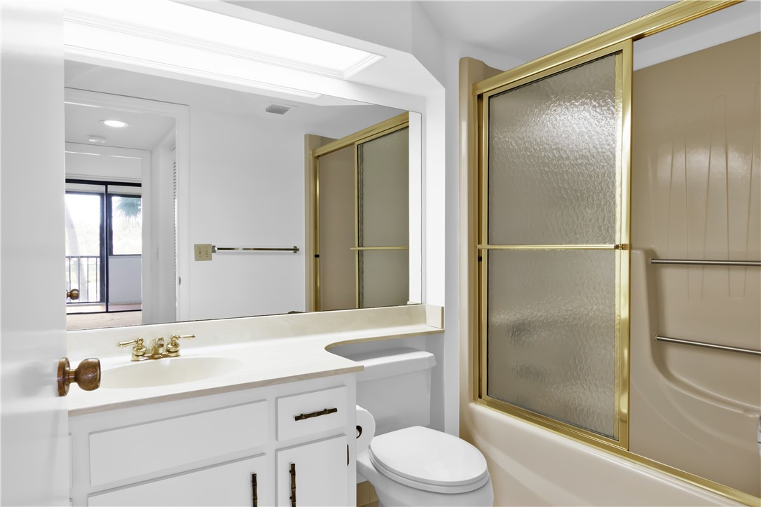 1850 Bay Road, Unit 2C Vero Beach, FL 32963 - Photo 17 of 36 a bathroom with a sink a toilet and shower