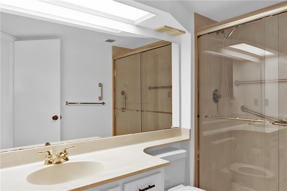 1850 Bay Road, Unit 2C Vero Beach, FL 32963 - Photo 19 of 36 a bathroom with a sink and a mirror