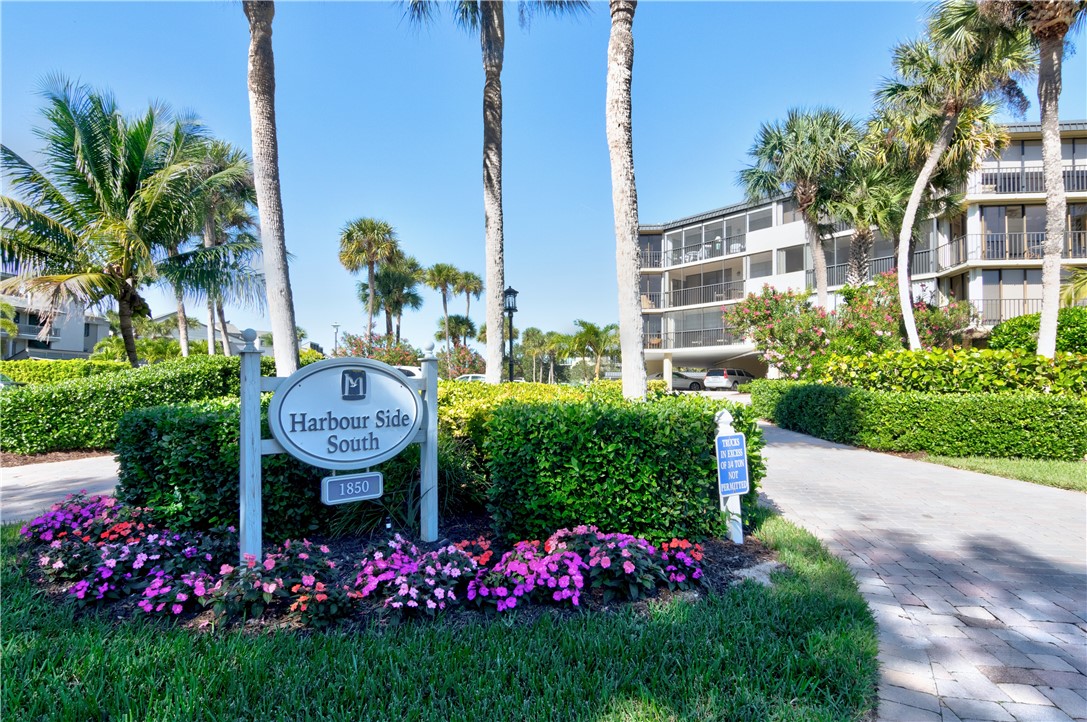 1850 Bay Road, Unit 2C Vero Beach, FL 32963 - Photo 3 of 36 a front view of multi story residential apartment building with yard and retail shops