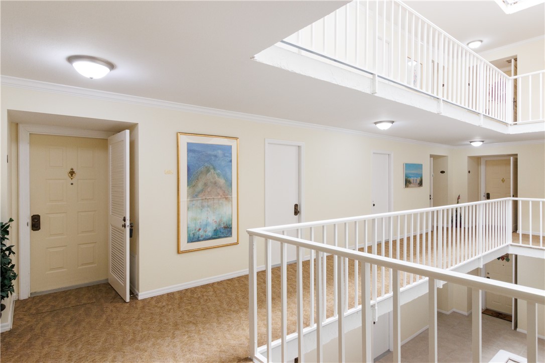 1850 Bay Road, Unit 2C Vero Beach, FL 32963 - Photo 4 of 36 a view of a hallway with windows and stairs