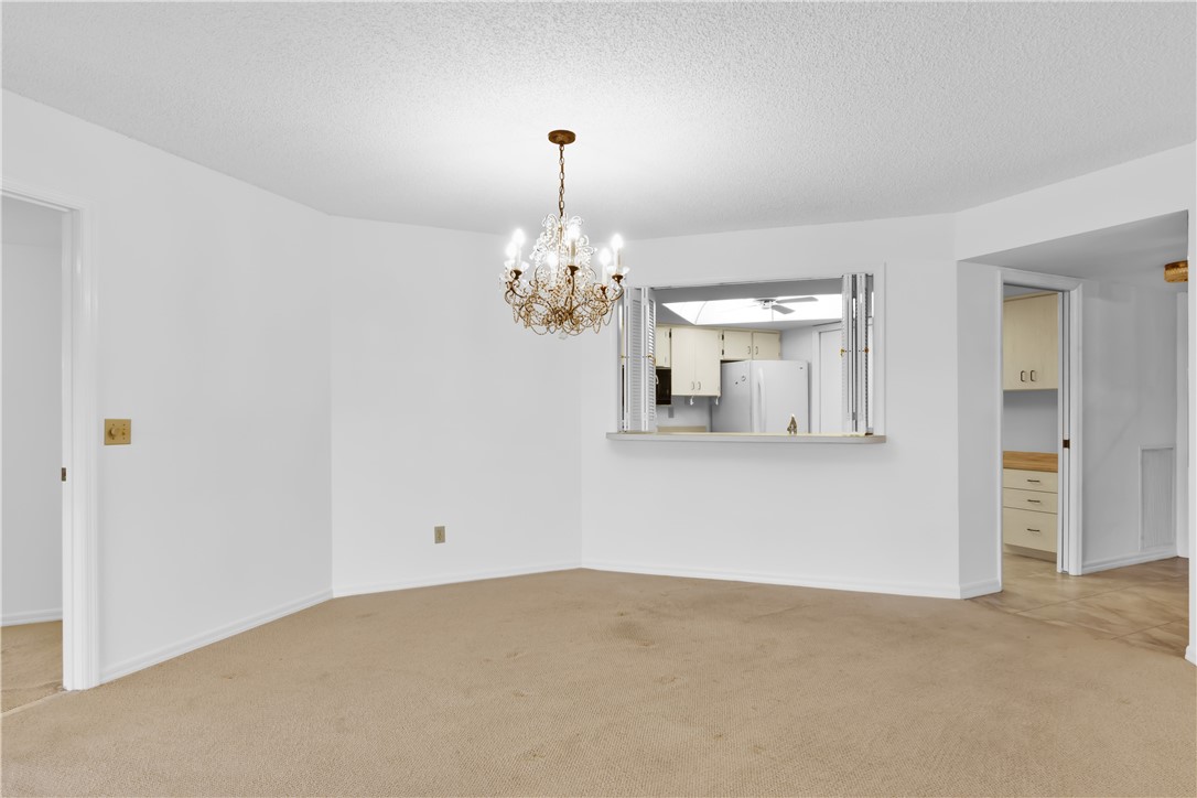 1850 Bay Road, Unit 2C Vero Beach, FL 32963 - Photo 5 of 36 a view of a chandelier and a chandelier fan in a room