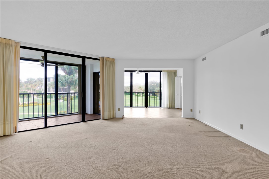 1850 Bay Road, Unit 2C Vero Beach, FL 32963 - Photo 6 of 36 a view of an empty room with windows and a balcony