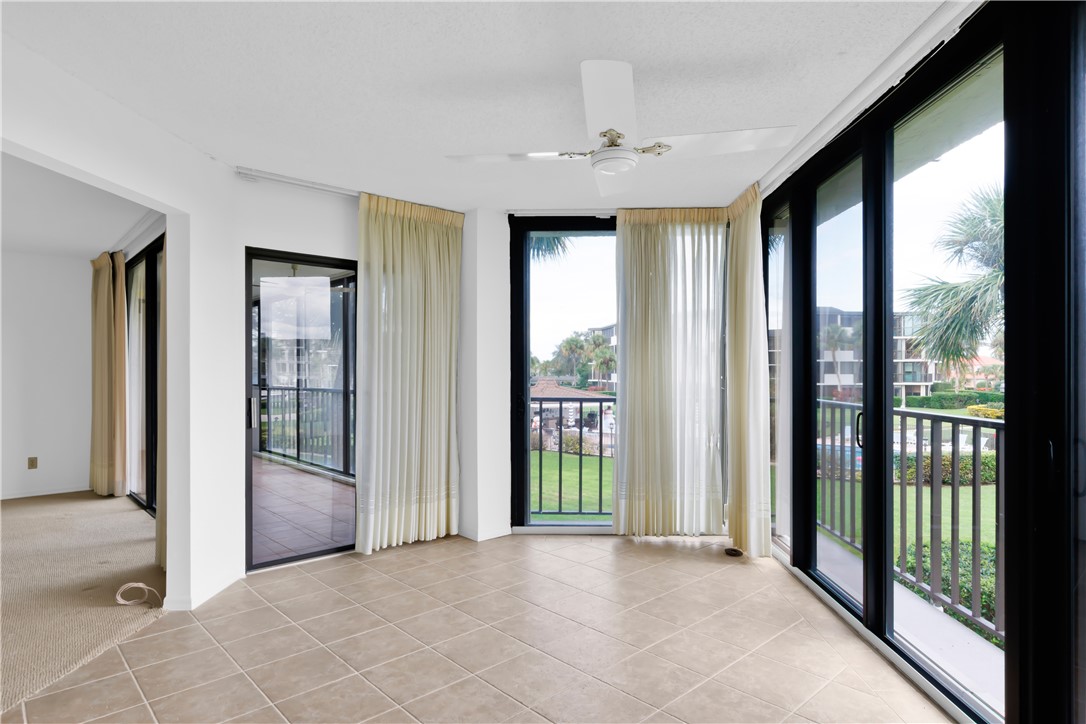 1850 Bay Road, Unit 2C Vero Beach, FL 32963 - Photo 9 of 36 a view of an empty room with glass door and balcony
