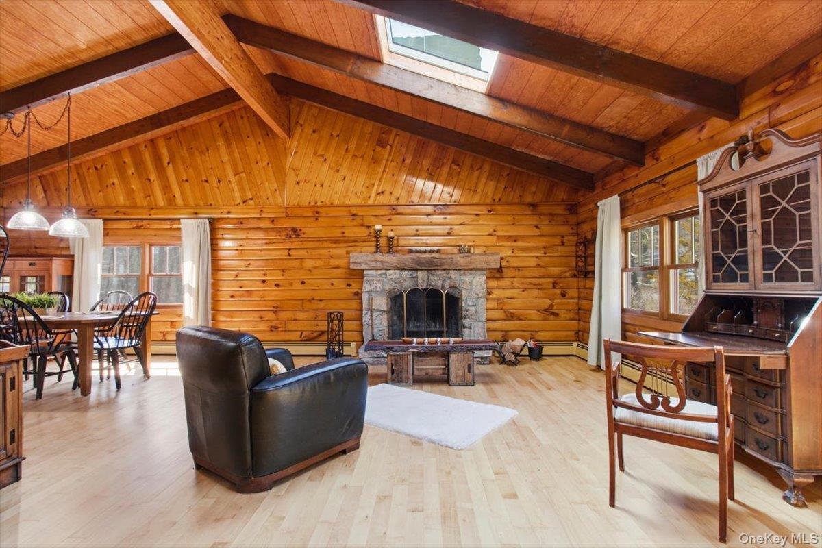 183 Bullet Hole Road Mahopac, NY 10541 - Photo 13 of 44 a living room with couches a barbecue grill and a fireplace