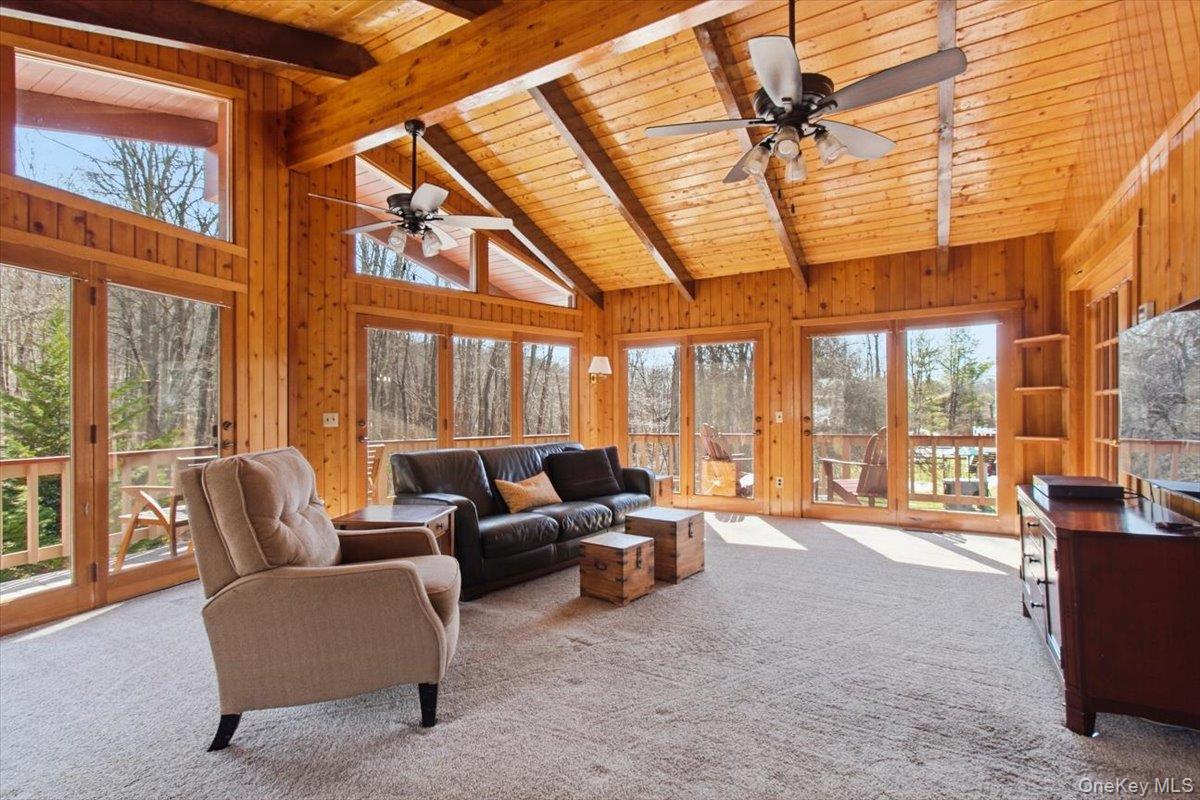 183 Bullet Hole Road Mahopac, NY 10541 - Photo 22 of 44 a living room with furniture and floor to ceiling windows