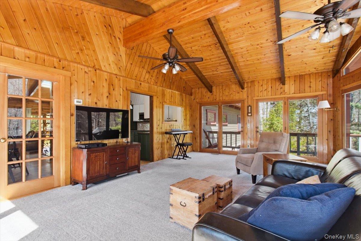 183 Bullet Hole Road Mahopac, NY 10541 - Photo 24 of 44 a living room with furniture a flat screen tv and large windows