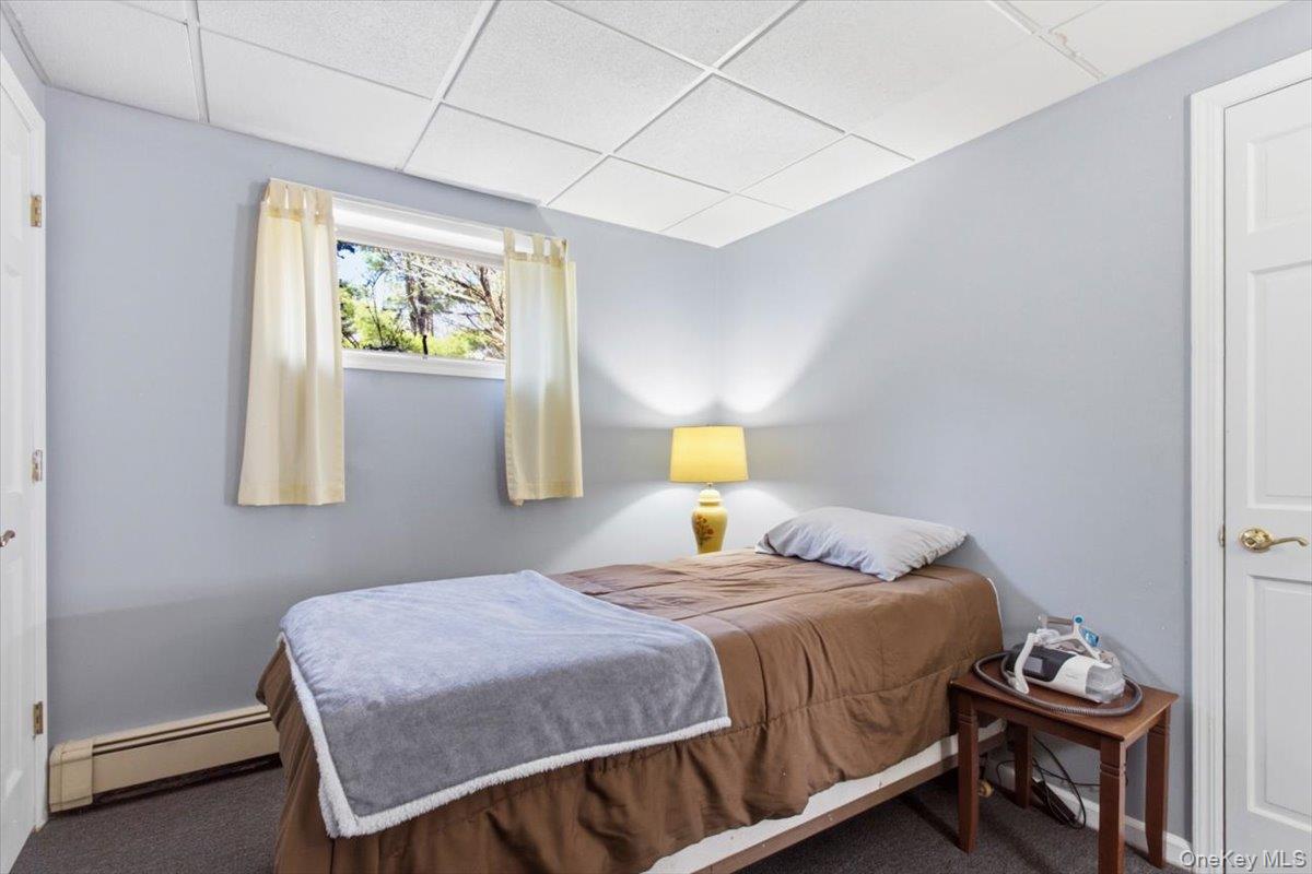 183 Bullet Hole Road Mahopac, NY 10541 - Photo 35 of 44 a bedroom with a bed and a table in it