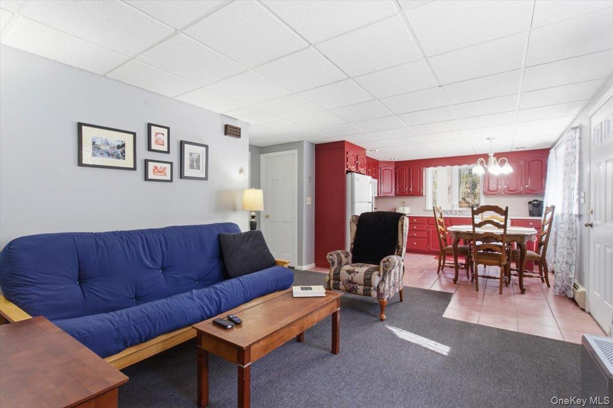 183 Bullet Hole Road Mahopac, NY 10541 - Photo 38 of 44 a living room with furniture kitchen view and a dining table