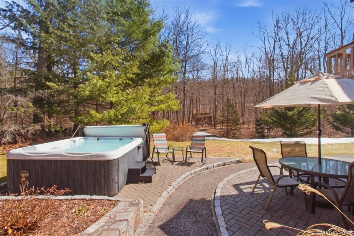 183 Bullet Hole Road Mahopac, NY 10541 - Photo 41 of 44 a patio with a table and chairs under an umbrella