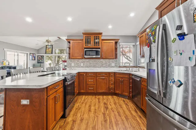 a kitchen with stainless steel appliances granite countertop a sink stove and refrigerator