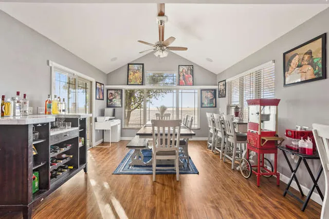 a living room with furniture a wooden floor and a chandelier
