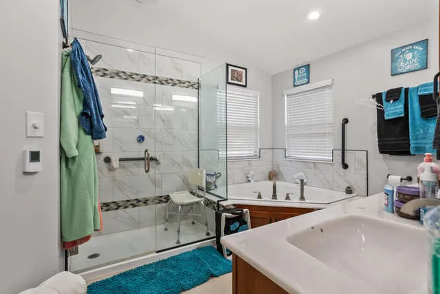 a bathroom with a granite countertop toilet sink and mirror