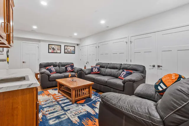 a living room with furniture a rug and a window