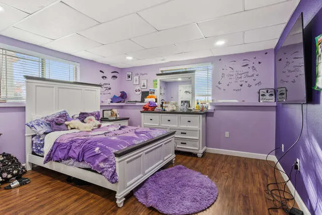 a bedroom with a bed and a flat screen tv