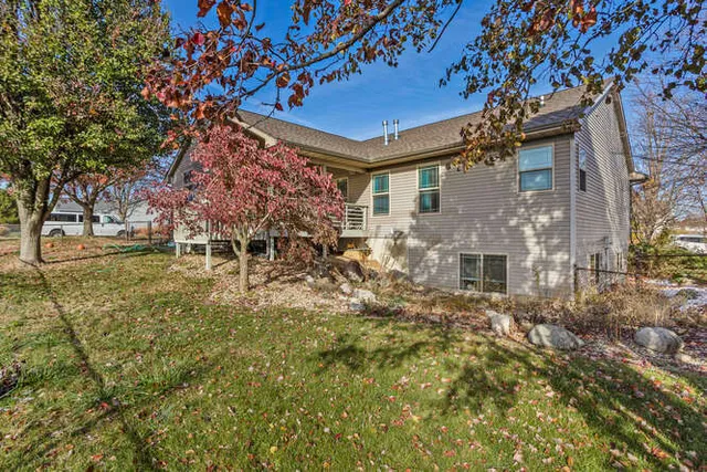 a tree in front of a white house