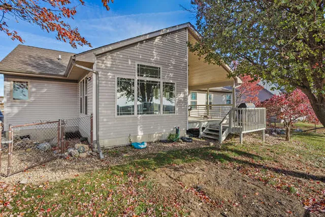 a view of a house with a yard and sitting area