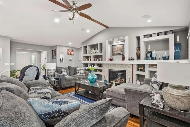 a living room with furniture fireplace and window