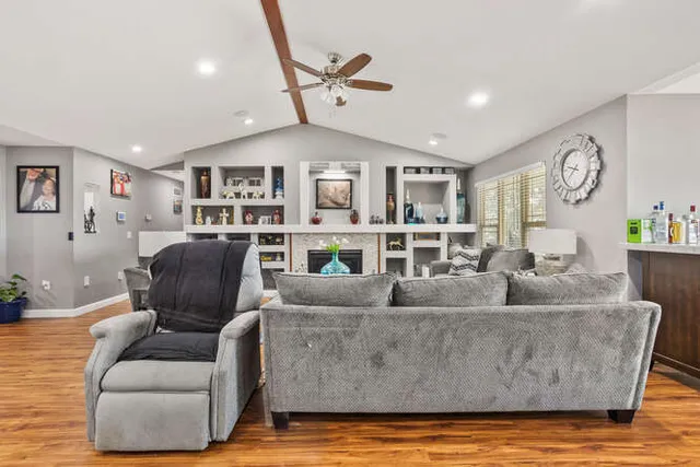 a living room with furniture and a wooden floor