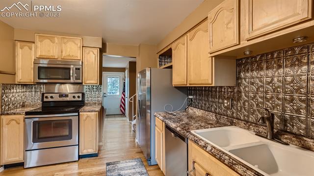 1412 Wooten Road Colorado Springs, CO 80915 - Photo 9 of 32 Kitchen - main/garage level