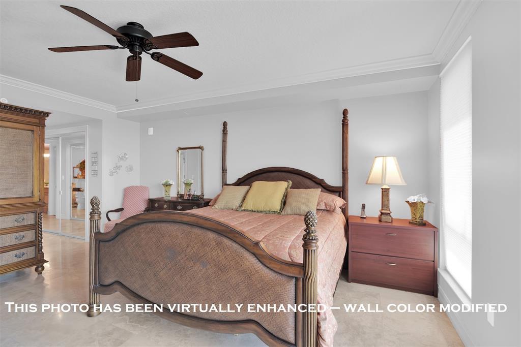 9 Northeast 20th Avenue, Unit 403 Deerfield Beach, FL 33441 - Photo 22 of 58 a bedroom with a bed and a chandelier