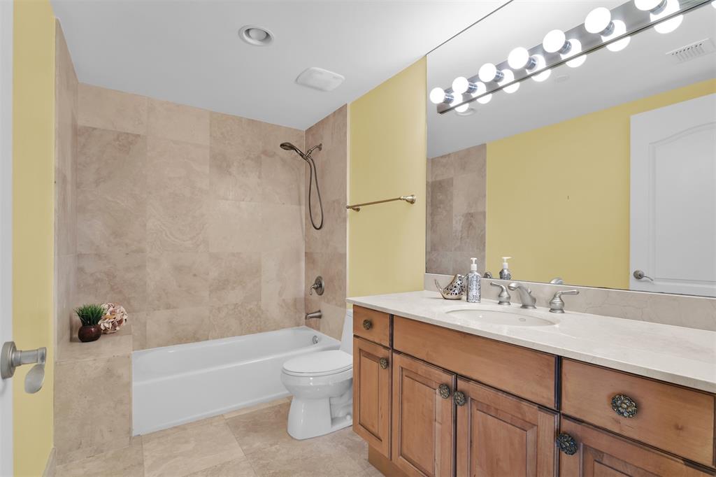 9 Northeast 20th Avenue, Unit 403 Deerfield Beach, FL 33441 - Photo 31 of 58 a bathroom with a double vanity sink mirror and a bathtub