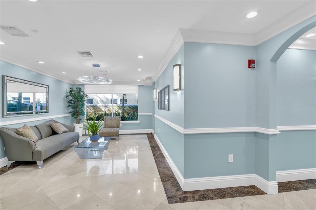 9 Northeast 20th Avenue, Unit 403 Deerfield Beach, FL 33441 - Photo 40 of 58 a living room with furniture and a rug
