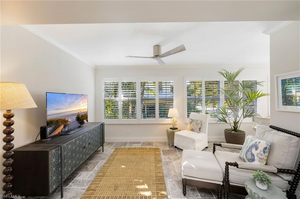 308 2nd Street South, Unit 308 Naples, FL 34102 - Photo 19 of 36 Sunny Sitting Room off of the Primary Bedroom. Disappearing louvered doors provide privacy when desired