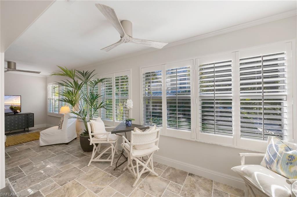 308 2nd Street South, Unit 308 Naples, FL 34102 - Photo 26 of 36 Expansive sun room located at the rear of the unit. Plantation shutters provide privacy.