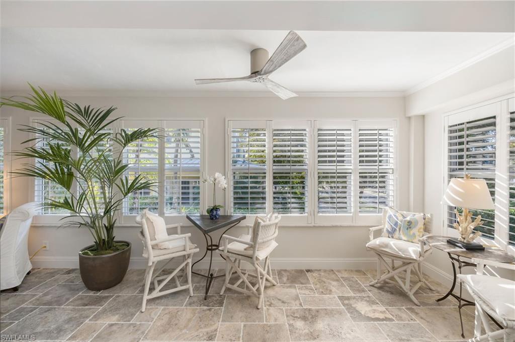 308 2nd Street South, Unit 308 Naples, FL 34102 - Photo 27 of 36 Light, bright sun room provides additional space for relaxing and entertaining.