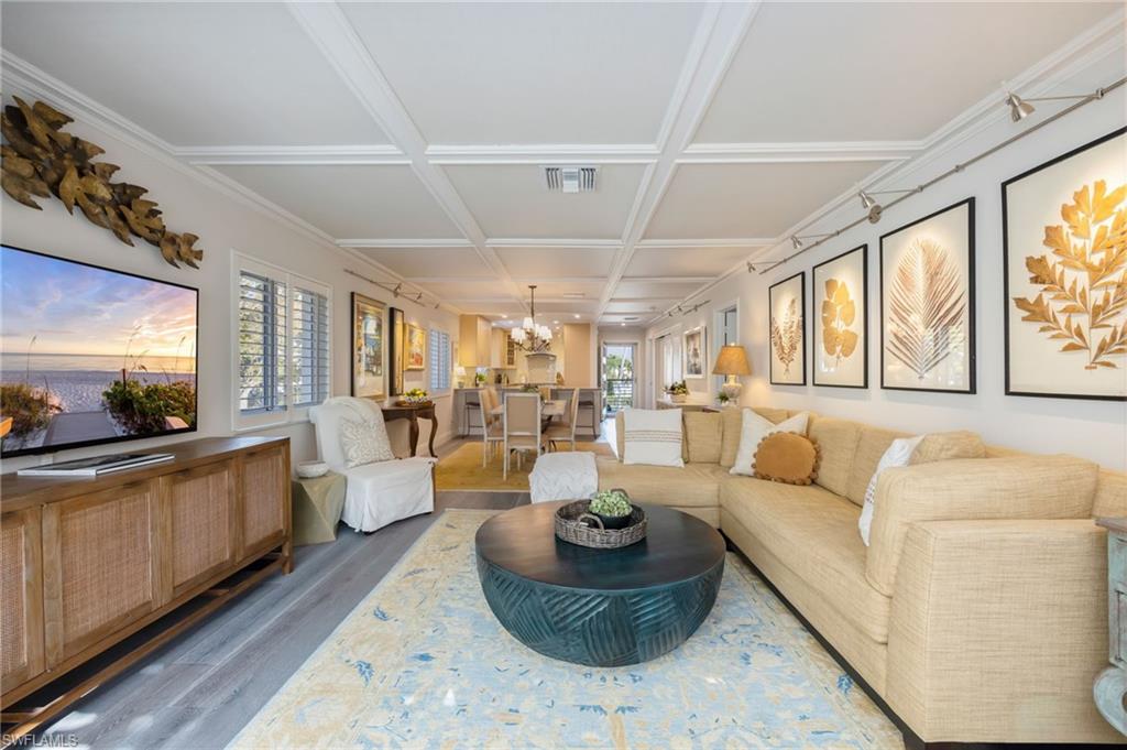 308 2nd Street South, Unit 308 Naples, FL 34102 - Photo 5 of 36 Light, bright living room is open to the dining area, kitchen and sun room.