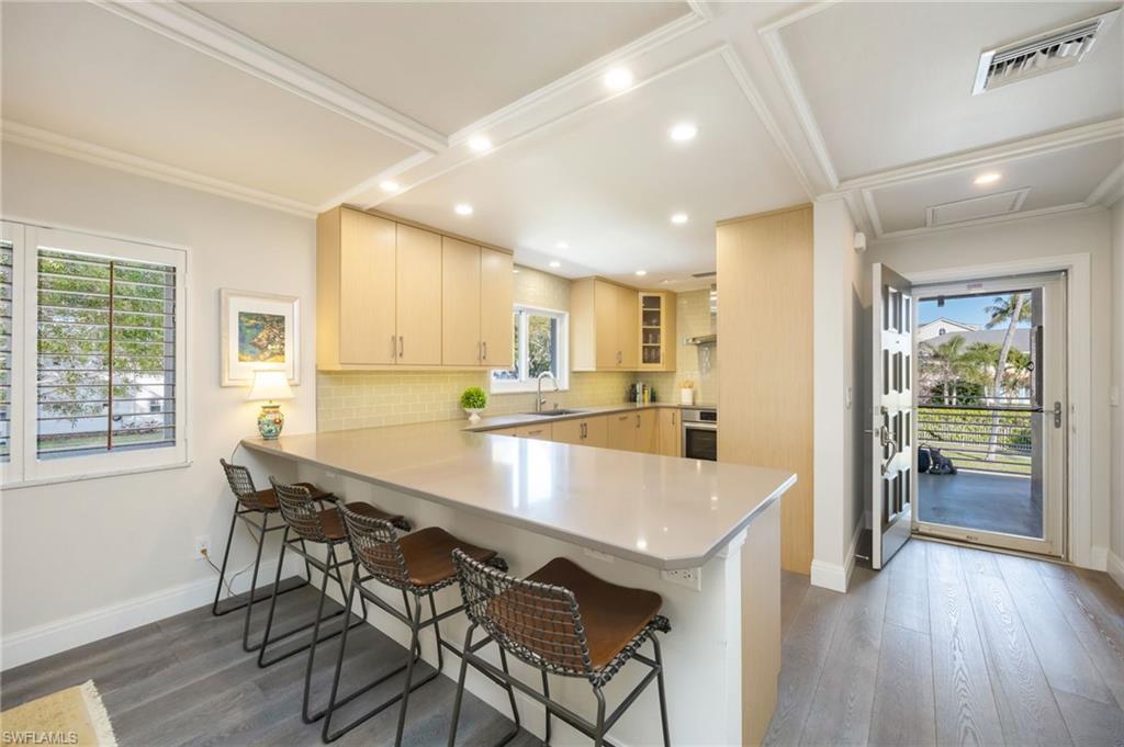 308 2nd Street South, Unit 308 Naples, FL 34102 - Photo 8 of 36 Casual dining doubles as seating for guests to keep the host company during meal prep