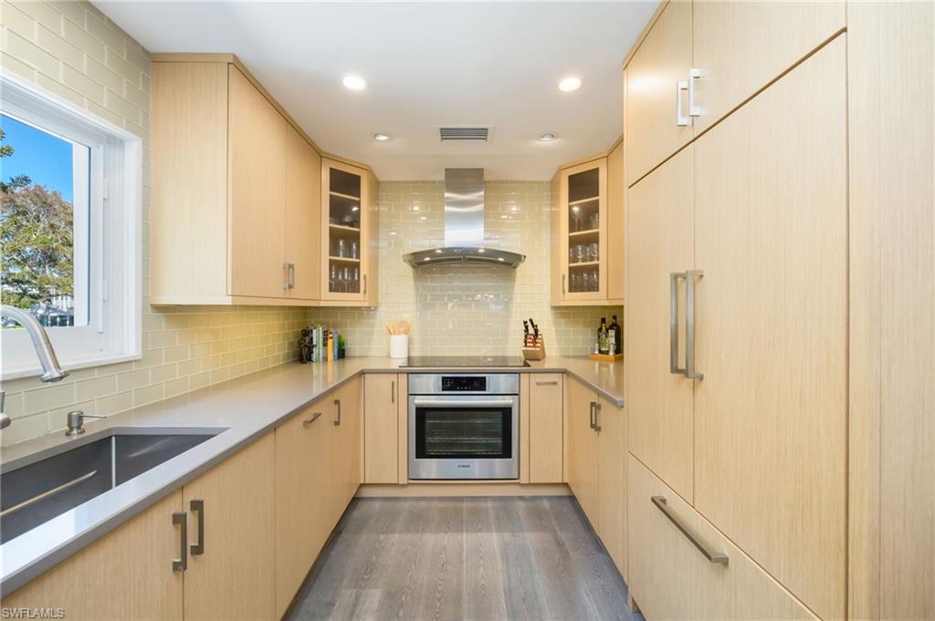 308 2nd Street South, Unit 308 Naples, FL 34102 - Photo 10 of 36 Newly remodeled custom kitchen features integrated cabinetry with custom