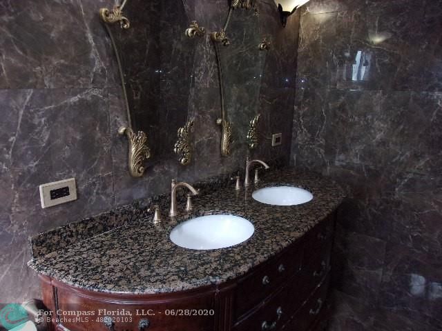 1564 Sunset Way Weston, FL 33327 - Photo 14 of 40 a bathroom with a granite countertop sink a mirror and shower