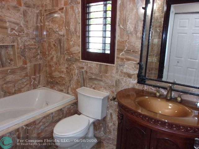 1564 Sunset Way Weston, FL 33327 - Photo 15 of 40 a bathroom with a granite countertop sink toilet and bathtub