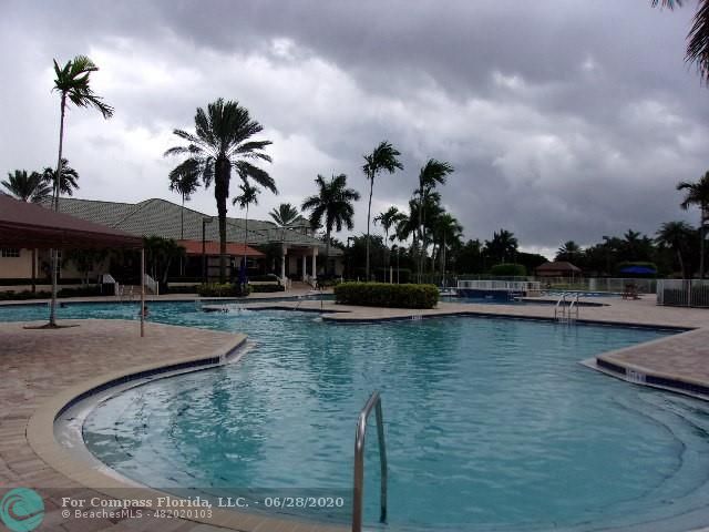 1564 Sunset Way Weston, FL 33327 - Photo 22 of 40 a view of a swimming pool with a yard