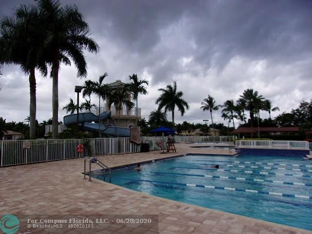 1564 Sunset Way Weston, FL 33327 - Photo 24 of 40 swimming pool with palm trees