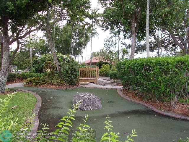 1564 Sunset Way Weston, FL 33327 - Photo 26 of 40 a view of a lake with a yard