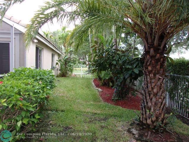 1564 Sunset Way Weston, FL 33327 - Photo 30 of 40 a view of a backyard with plants