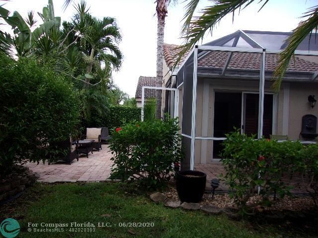 1564 Sunset Way Weston, FL 33327 - Photo 31 of 40 a view of a house with brick walls and a yard with plants