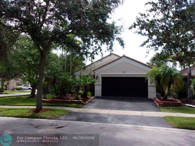 1564 Sunset Way Weston, FL 33327 - Photo 36 of 40 a front view of a house with a yard