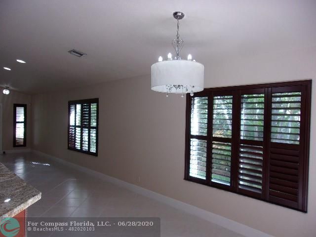 1564 Sunset Way Weston, FL 33327 - Photo 8 of 40 a view of a hallway with windows