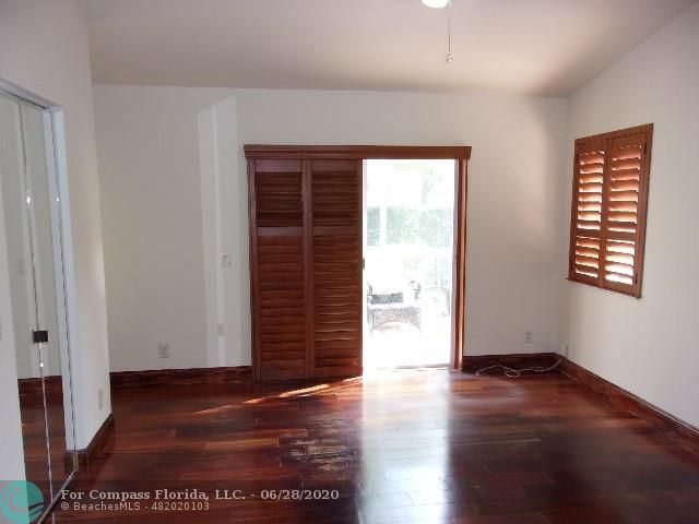 1564 Sunset Way Weston, FL 33327 - Photo 9 of 40 an empty room with wooden floor and windows