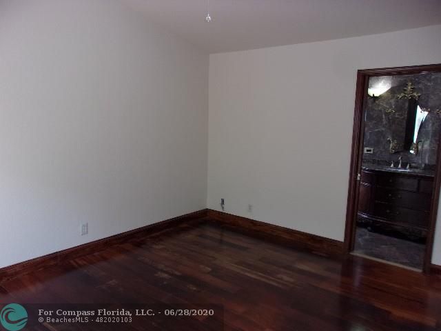 1564 Sunset Way Weston, FL 33327 - Photo 10 of 40 a view of a hallway with wooden floor