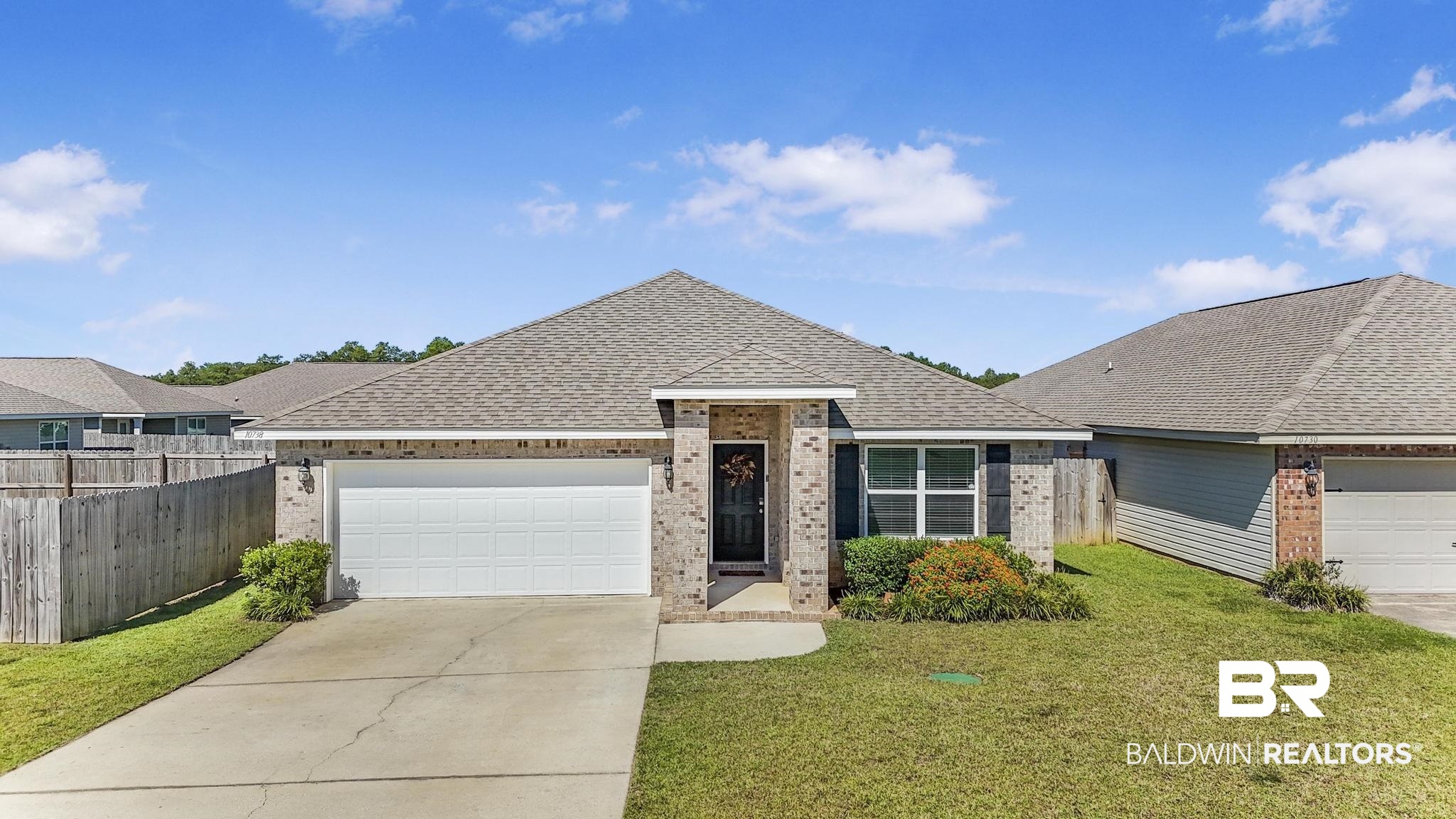 10738 Ridgeview Drive Mobile, AL 36608 - Photo 35 of 48 Ranch-style house featuring brick siding, roof with shingles, an attached garage, and concrete driveway