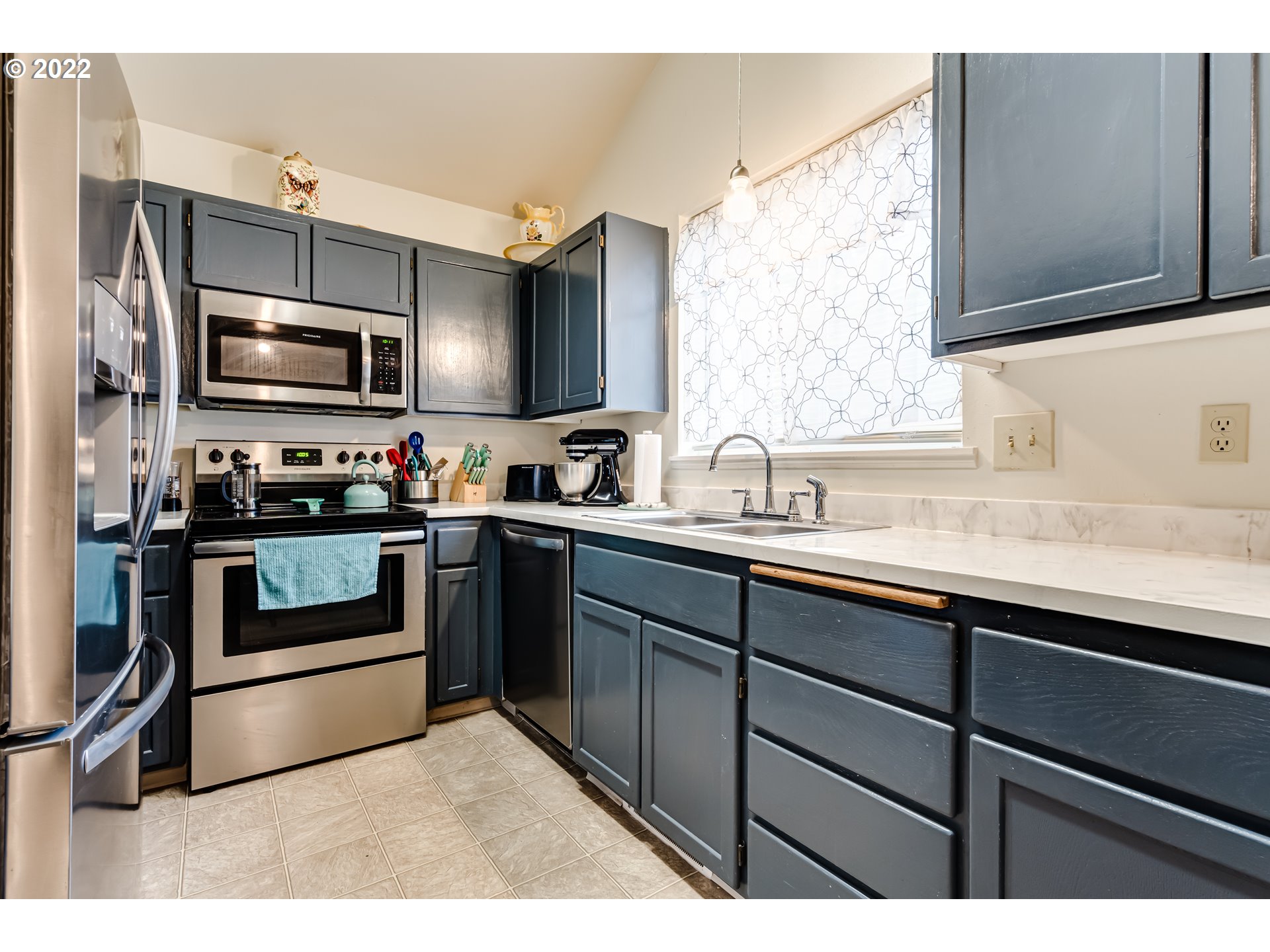 355 South 70th Street Springfield, OR 97478 - Photo 8 of 25 a kitchen with stainless steel appliances a stove sink microwave and cabinets