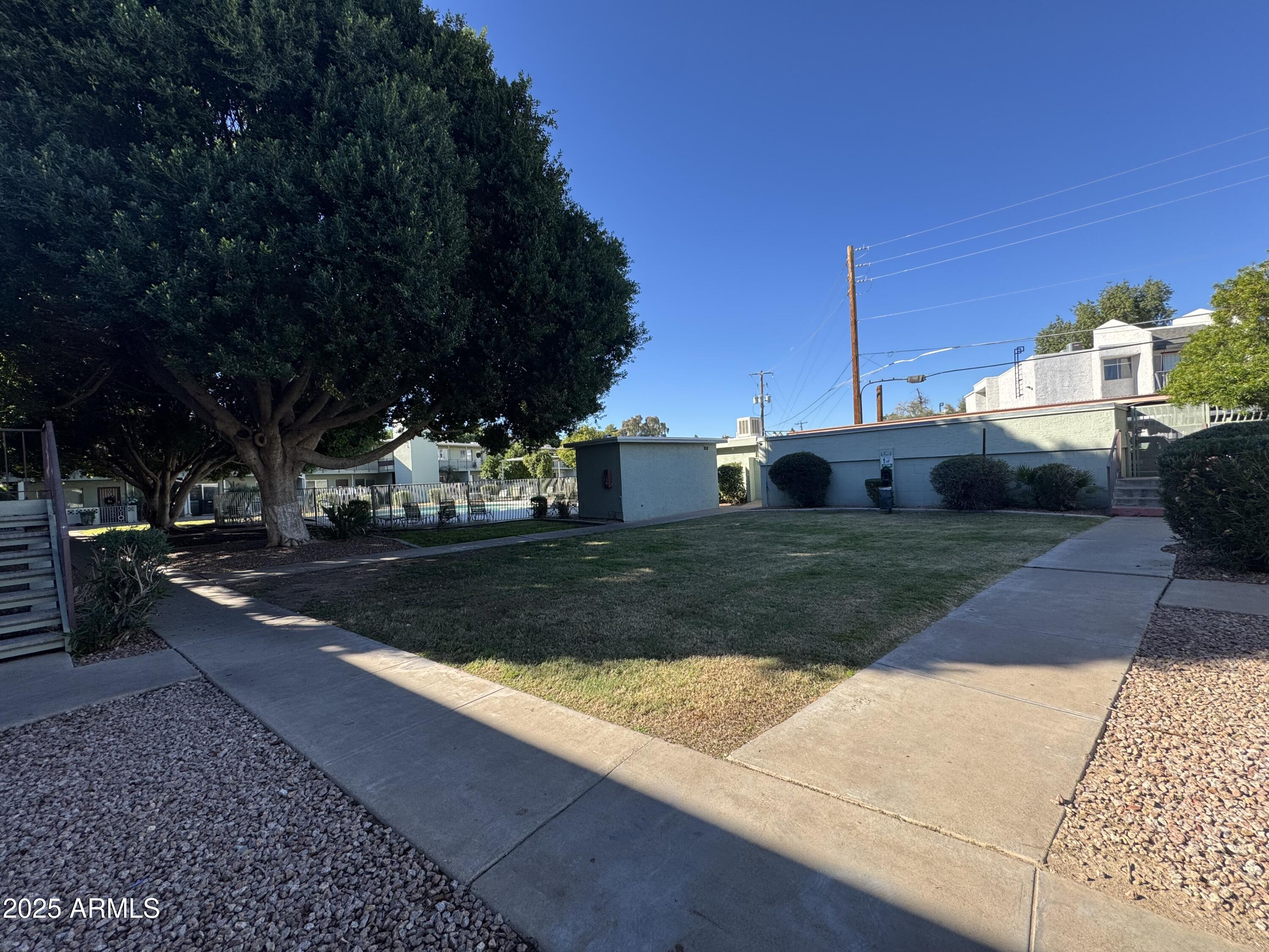 1702 West Tuckey Lane, Unit 231 Phoenix, AZ 85015 - Photo 19 of 26 a view of a yard with cars on the road