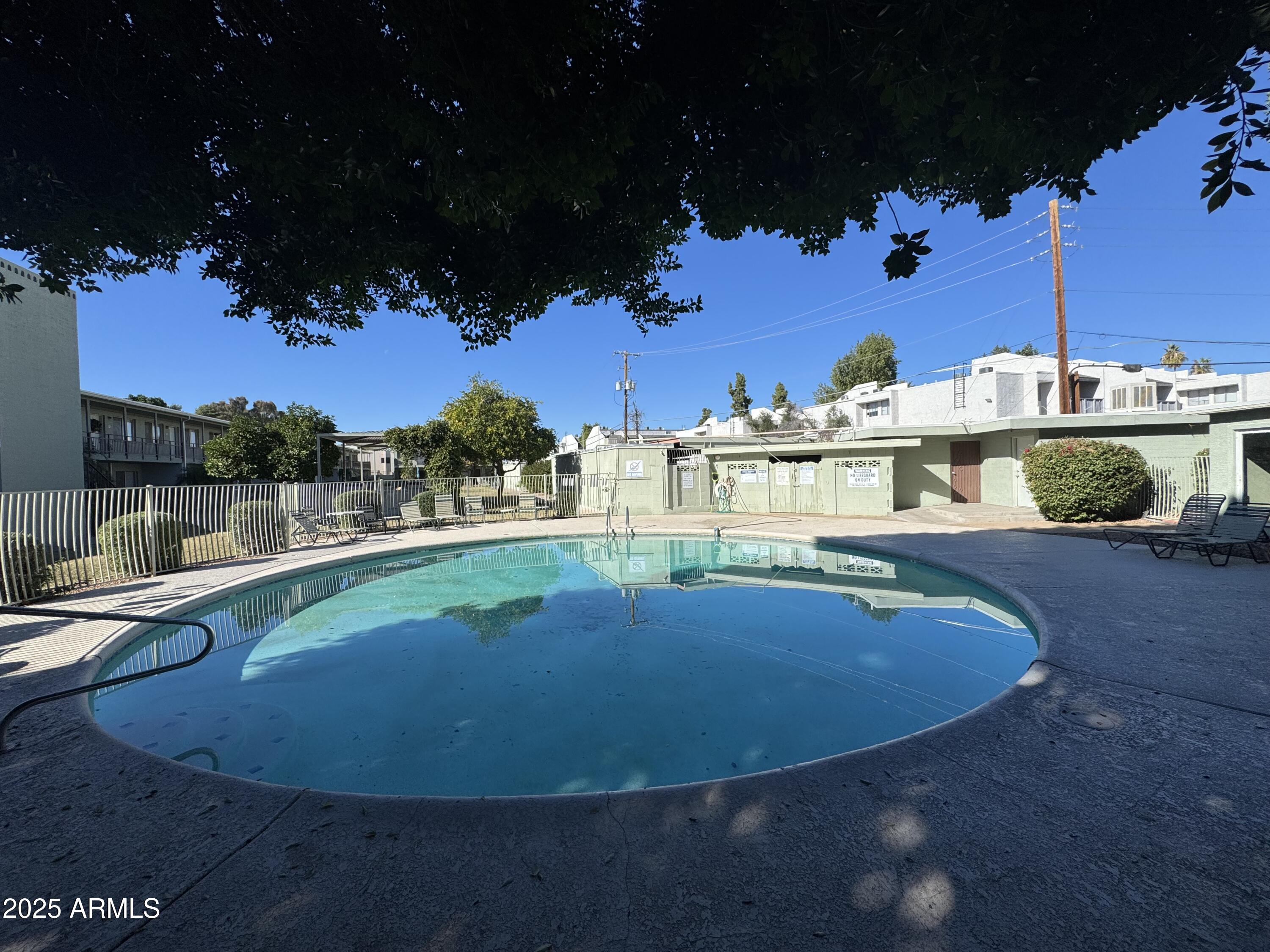 1702 West Tuckey Lane, Unit 231 Phoenix, AZ 85015 - Photo 20 of 26 a view of a swimming pool with a house