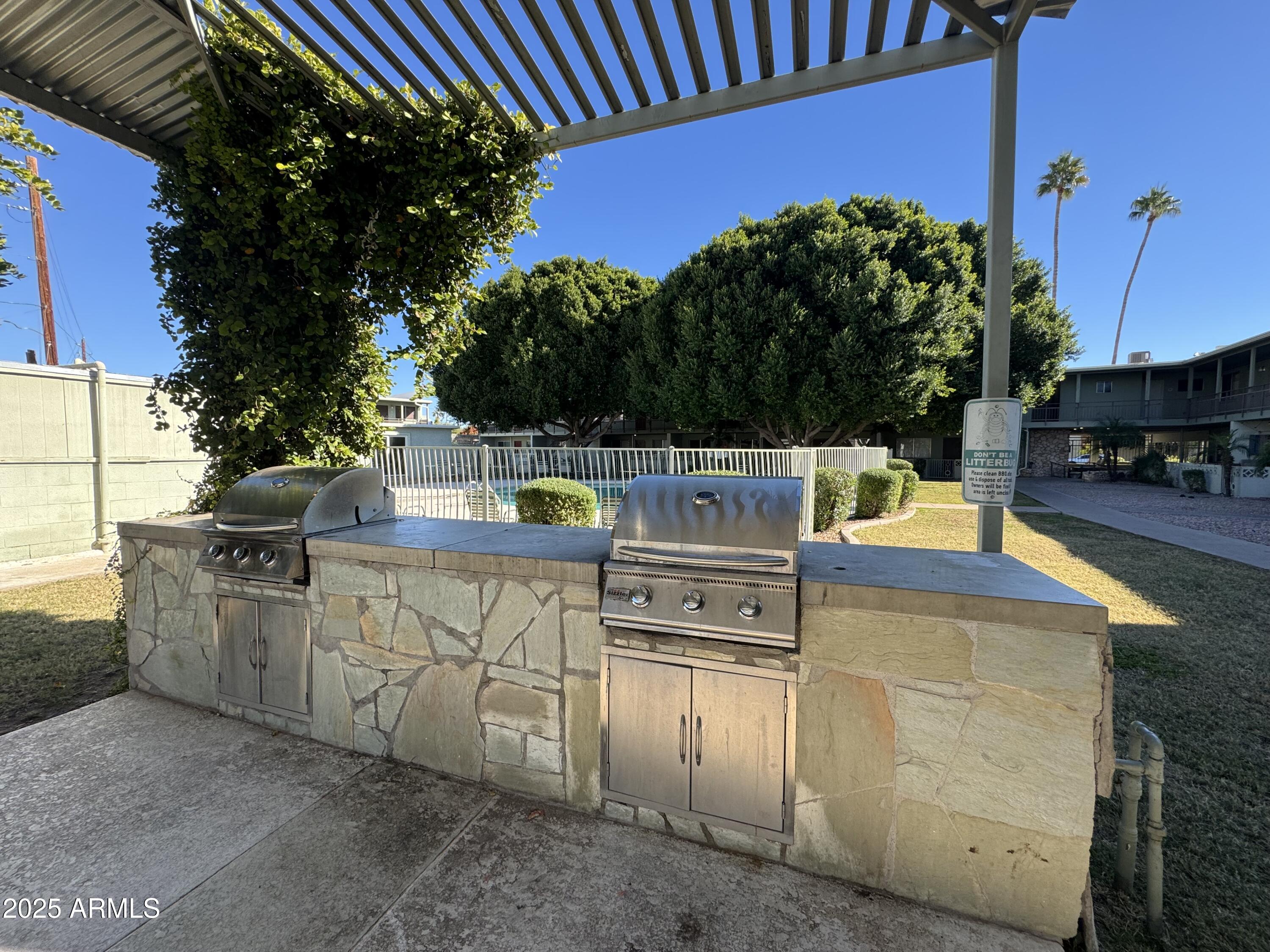 1702 West Tuckey Lane, Unit 231 Phoenix, AZ 85015 - Photo 22 of 26 a view of a chairs and table on the terrace