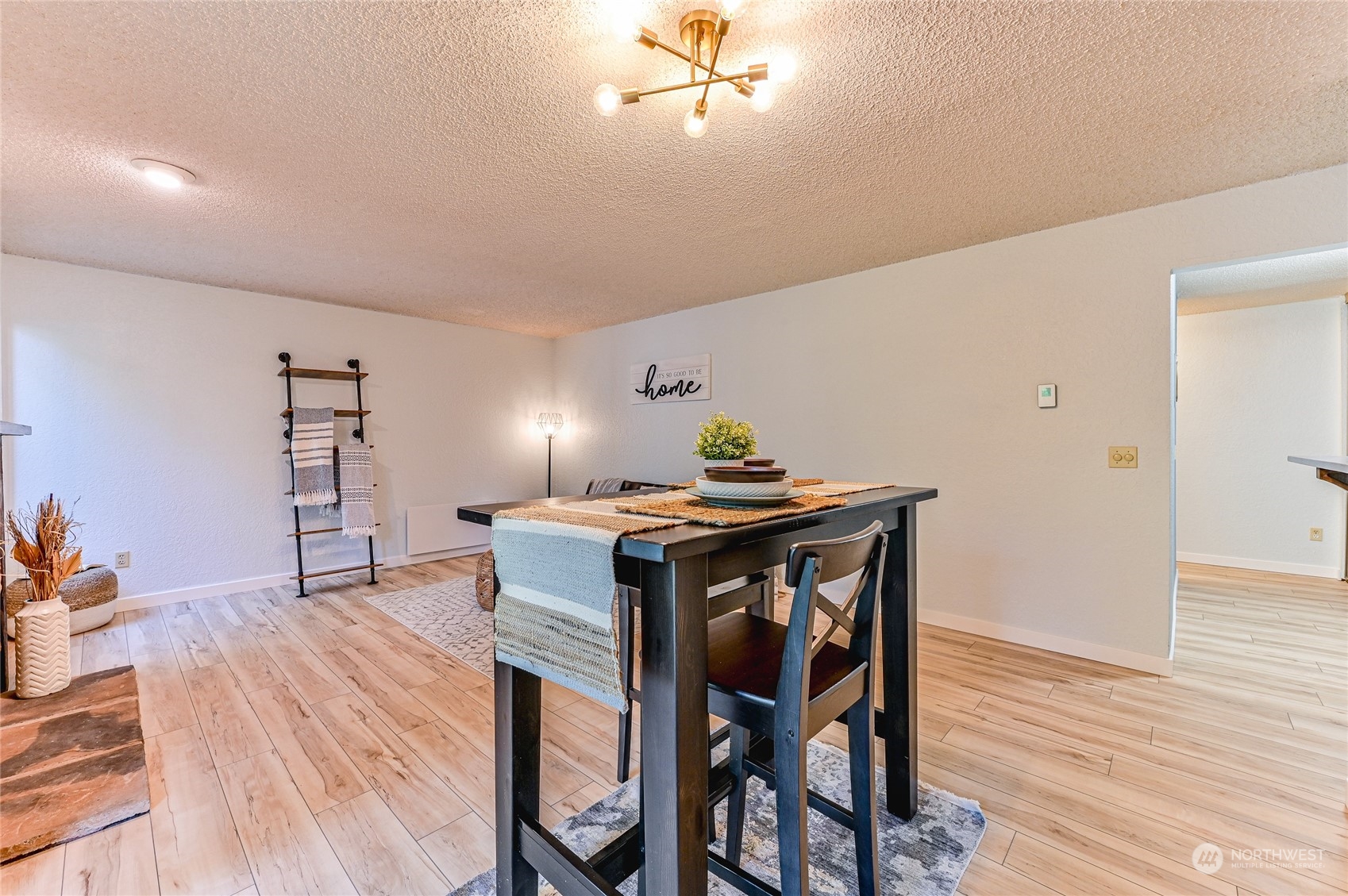 14401 Southeast Petrovitsky Road, Unit E105 Renton, WA 98058 - Photo 14 of 38 a view of a dining room with furniture and wooden floor