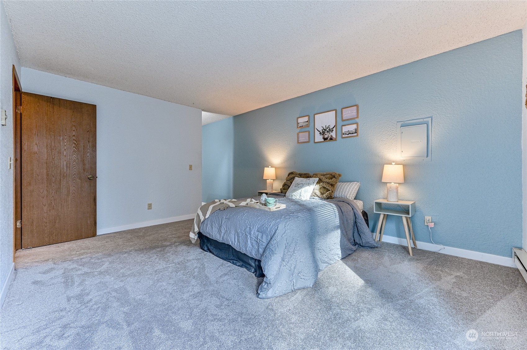 14401 Southeast Petrovitsky Road, Unit E105 Renton, WA 98058 - Photo 19 of 38 a bed room with a bed and a lamp
